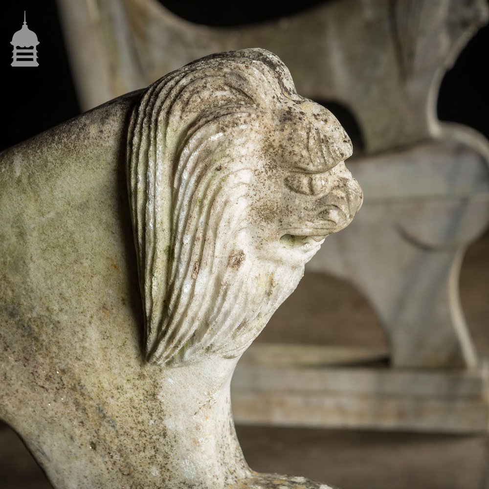 Pair of Weathered Marble Bench Ends with Carved Dragon Design