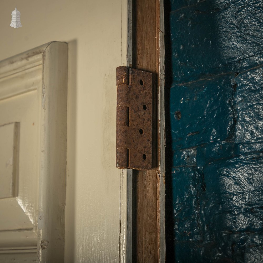 Heavy fire door with mouldings on one side to create panelled appearance.